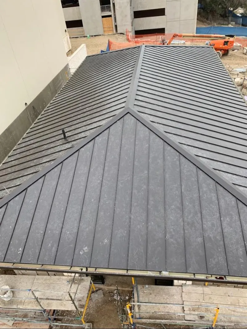 Commercial metal roof construction with crane equipment in Beverly Hills